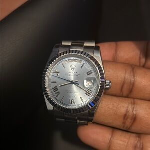 Rolex Silver Luxury Watch with Fluted Bezel and Date Window
